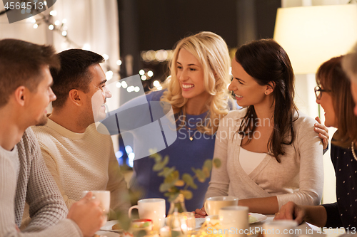 Image of happy family having tea party at home