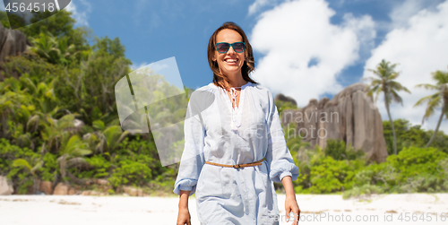 Image of happy woman over seychelles island tropical beach