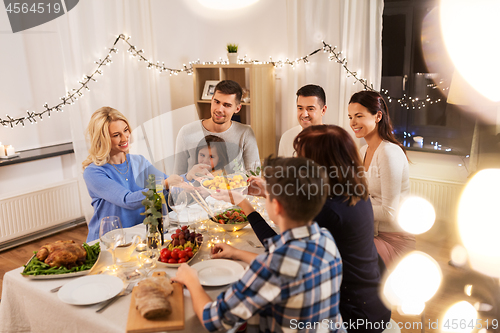 Image of happy family having dinner party at home