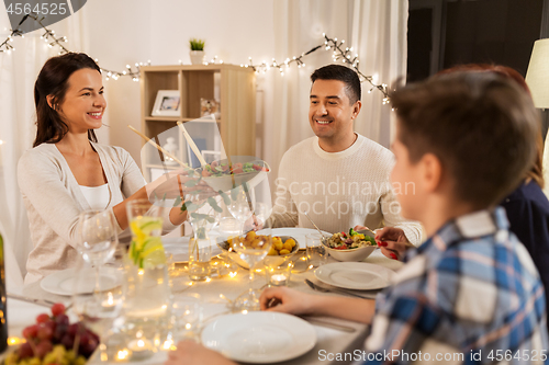 Image of happy family having dinner party at home