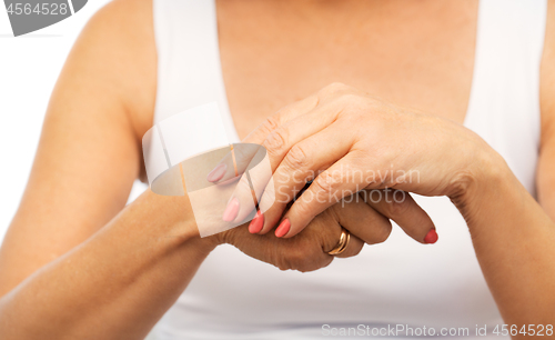 Image of close up of senior woman hands with manicure