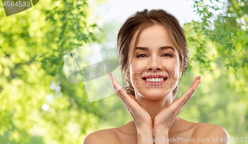 Image of smiling young woman over grey background