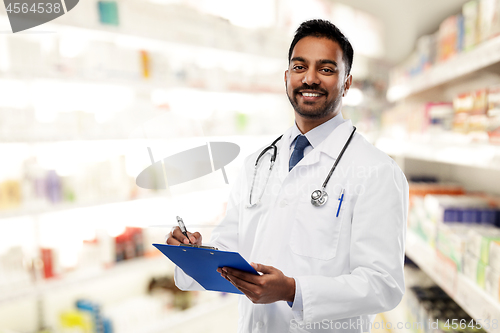 Image of indian male doctor with clipboard and stethoscope