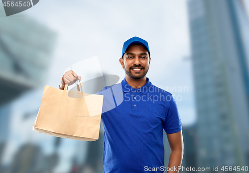 Image of happy indian delivery man with food in paper bag