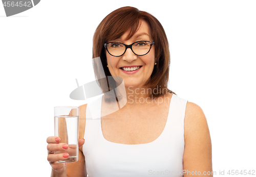 Image of senior woman in glasses with glass of water