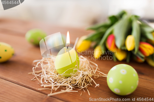 Image of candle in shape of easter eggs and tulip flowers