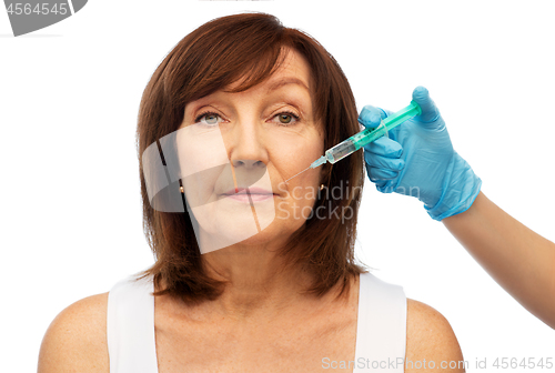 Image of senior woman and surgeon hand with syringe