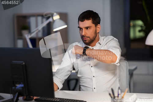 Image of businessman using voice command on smart watch