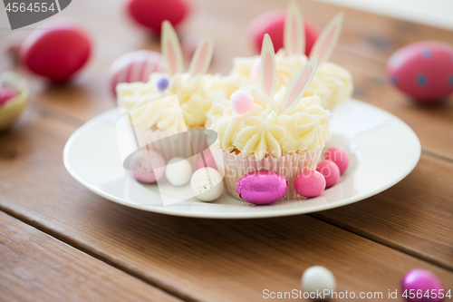 Image of cupcakes with easter eggs and candies on table