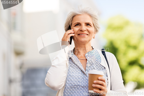 Image of senior woman calling on smartphone in city