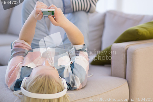 Image of girl enjoying music through headphones