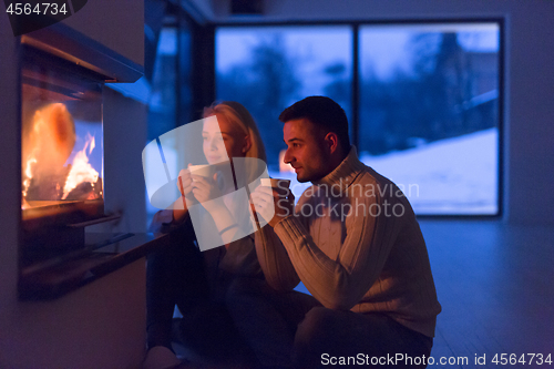 Image of happy couple in front of fireplace