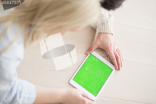 Image of Young Couple using digital tablet on cold winter day