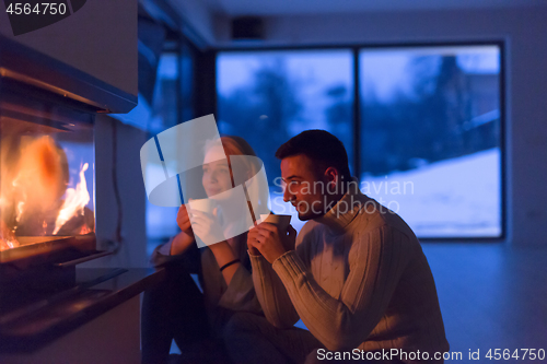 Image of happy couple in front of fireplace