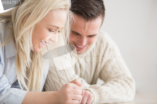 Image of Young Couple using digital tablet on cold winter day