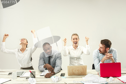 Image of Young men and women sitting at office and working on laptops. Emotions concept