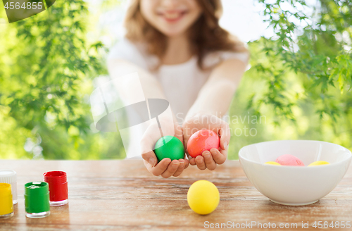 Image of close up of girl holding colored easter eggs