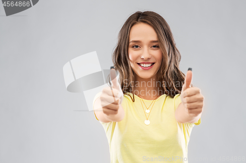 Image of young woman or teenage girl showing thumbs up