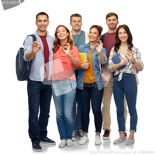 Image of group of smiling students showing ok hand sign