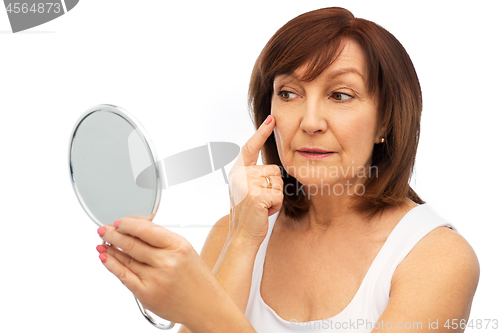 Image of portrait of smiling senior woman with mirror