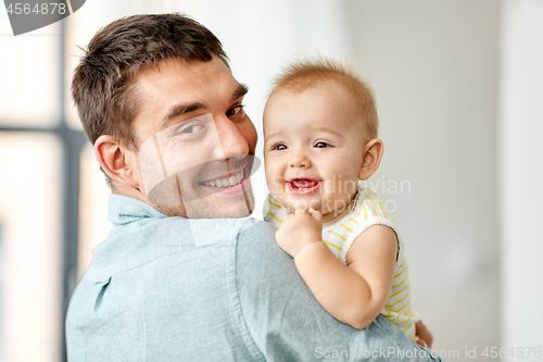 Image of happy father holding little baby daughter at home