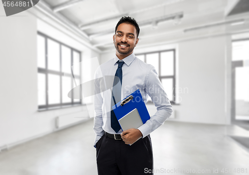 Image of indian businessman or realtor in empty office room