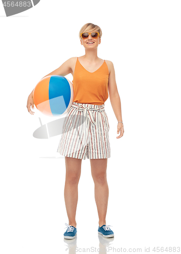 Image of smiling teenage girl in sunglasses with beach ball