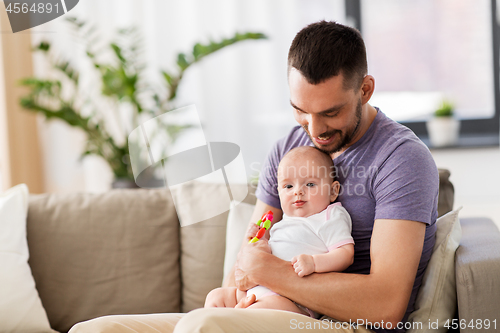 Image of happy father with little baby daughter at home