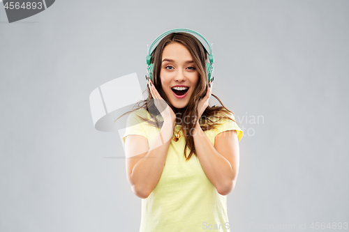 Image of happy young woman or teenage girl with headphones