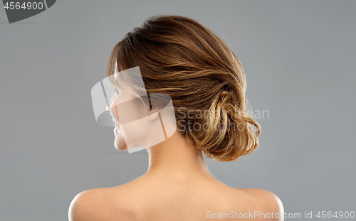 Image of young woman from back over grey background