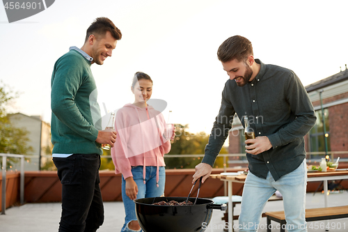 Image of happy friends having bbq party on rooftop