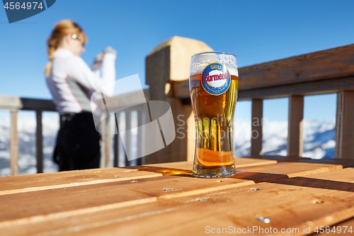 Image of Having a beer on a terrace with scenic view, winter in the mountains