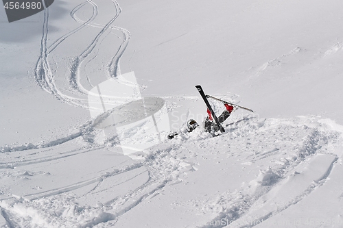 Image of Skier falls in deep snow