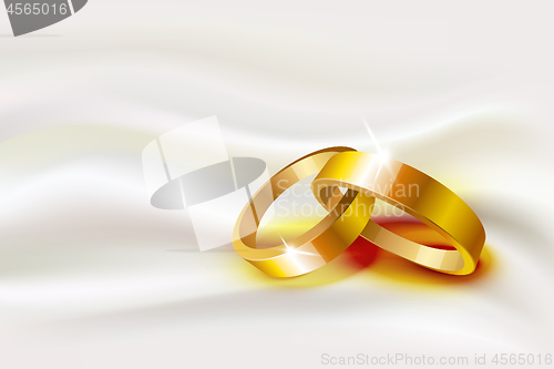 Image of Two wedding rings on silk background