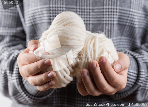 Image of Detail of hands holding wool for knitting