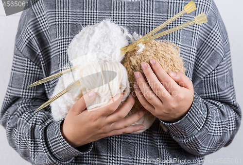 Image of Detail of hands holding wool for knitting