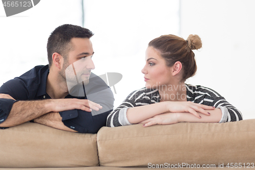 Image of Portrait of young couple sitting on sofa