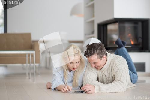 Image of Young Couple using digital tablet on cold winter day