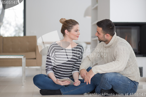 Image of Young Couple using digital tablet on cold winter day