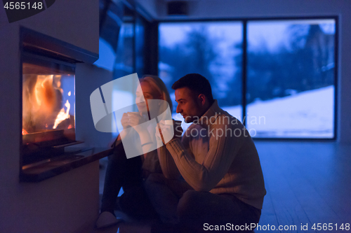 Image of happy couple in front of fireplace