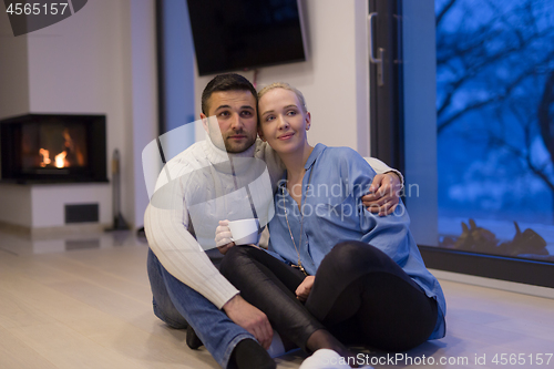 Image of happy couple in front of fireplace