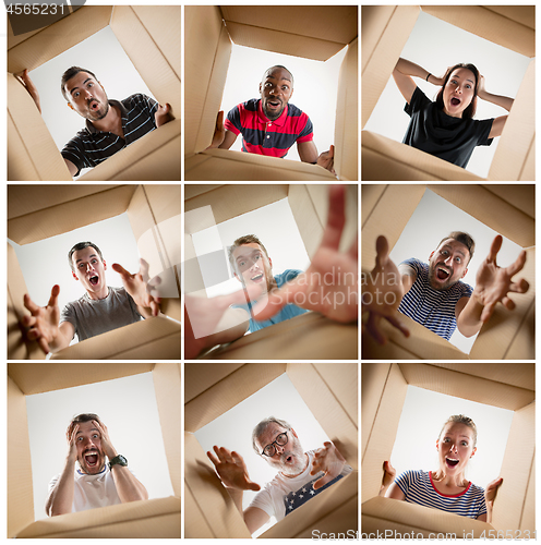 Image of The men and women unpacking and opening carton box and looking inside