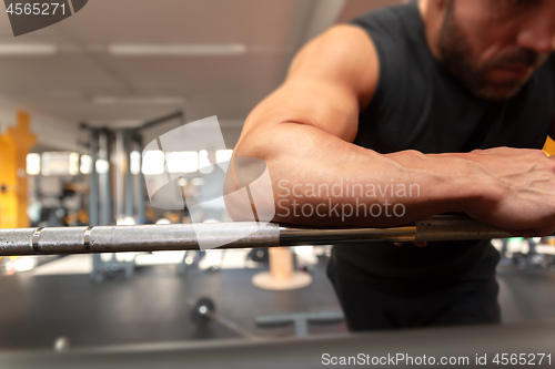 Image of a strong man relaxes in the gym