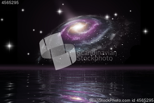 Image of spiral galaxy over the ocean