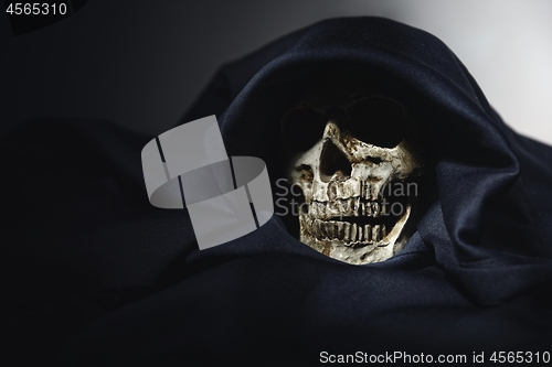 Image of Closeup photo an old skull covered in black robe