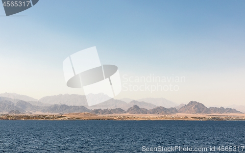 Image of land over the horizon under blue sky