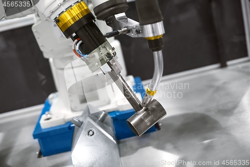 Image of Automatic robot arm working in industrial environment