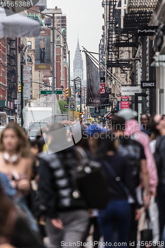 Image of New York, NY, USA - May 17, 2018: Crowds of people walking sidewalk of Broadway avenue in Soho of Midtown Manhattan on may 17th, 2018 in New York City, USA.