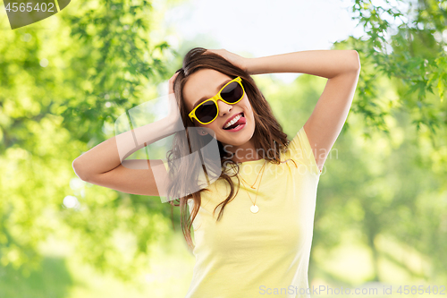 Image of teenage girl in yellow sunglasses and t-shirt