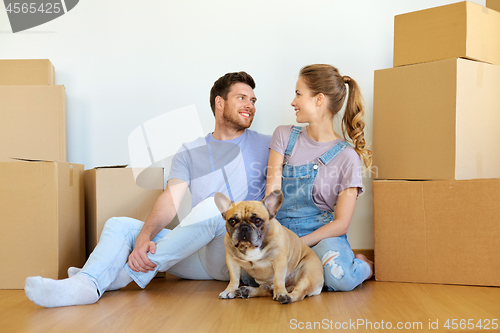 Image of happy couple with boxes and dog moving to new home